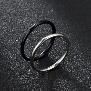 Minimalist 2mm stainless steel band ring set in polished black and silver finishes