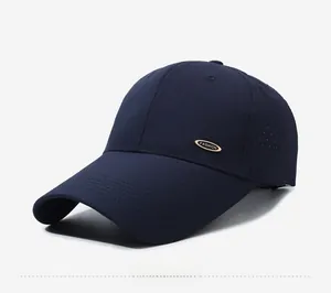 Detailed close-up of navy blue mesh baseball cap with golden fashion metal emblem