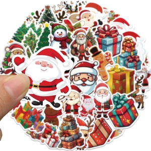 Close-up of hand holding a cartoon Santa Claus sticker from the 100-piece Christmas set