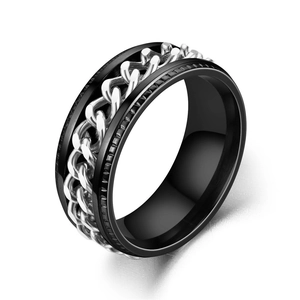 Macro view of a black titanium steel spinner ring featuring a rotatable silver chain inlay