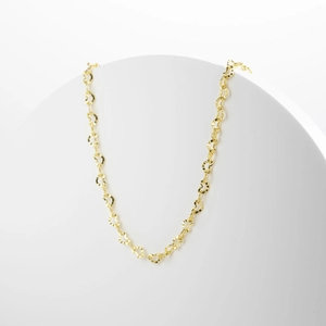 Detailed view of the gold heart-shaped link chain necklace on a white display stand