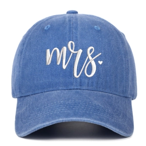 Detail of white cursive Mrs embroidery with heart on blue washed denim baseball cap
