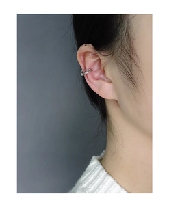 Close-up of minimalist double-layer silver ear cuff on model for a modern look