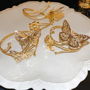 Elegant gold butterfly open cuff bracelet set with sparkling crystal flower accents