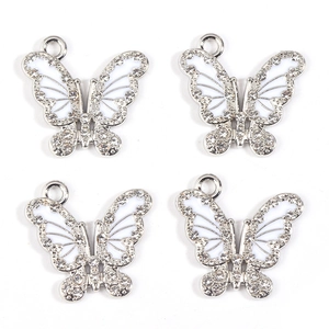 Detailed view of four silver butterfly pendants with white inlay and clear rhinestones
