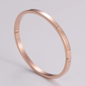 Detail view of the rose gold minimalist metal bracelet showing side clasp mechanism