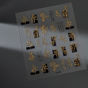 Macro detail of gold embossed bamboo nail stickers with artistic calligraphy design