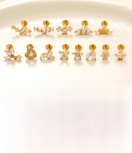 Detailed macro view of gold-plated stainless steel labret studs with zircon butterfly