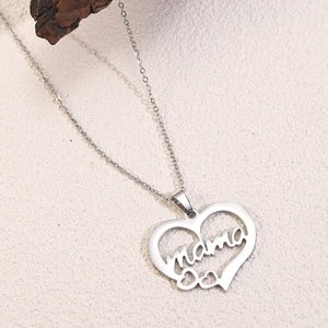 Macro shot of silver stainless steel heart necklace featuring a hollow mama letter design