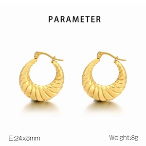 Macro shot showing 24x8mm golden oval earrings with distinctive spiral ribbed texture
