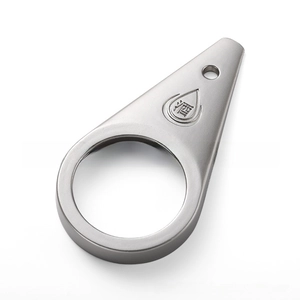 Close-up of a teardrop-shaped stainless steel bottle opener with engraved Chinese character