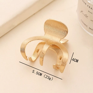 Textured gold metal hair claw clip measuring 5.5cm by 4cm for a secure ponytail