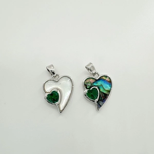 Detail of heart pendants featuring white mother of pearl and abalone shell with 18K plating