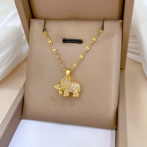 Close-up of gold plated elephant pendant with micro-pave zircons in a jewelry box