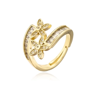 Detail of golden adjustable ring featuring cubic zirconia flowers and geometric stones