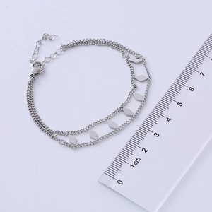 Detail of double-layer stainless steel bracelet with rhombus charms and measuring ruler