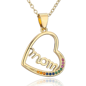 Detail of gold heart pendant with hollow 'mom' script and colorful rainbow gemstones