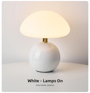 Detail of mushroom lamp showing warm yellow light and sleek white ceramic finish