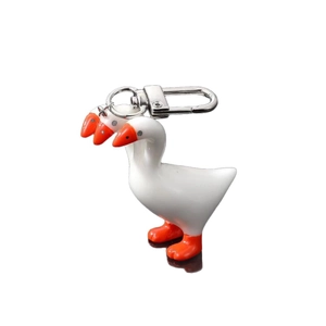 Quirky three-headed white goose keychain with orange beak and silver metal clip