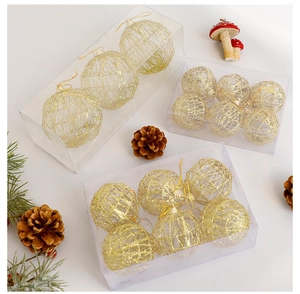 Detail of hollow gold glitter Christmas ornaments in luxury gift box packaging