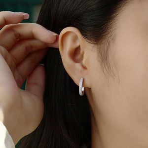 925 sterling silver U-shaped hoop earrings with moissanite crystals worn by a model