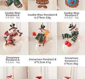 Detail view of resin gingerbread man and snowman Christmas ornaments with rustic twine