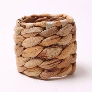 Natural woven bamboo napkin ring with rustic grass texture on white background