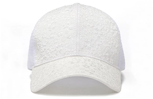 Macro view of white floral lace pattern and breathable mesh on a ladies baseball cap
