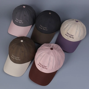 Flat lay of breathable baseball caps with contrast colors and custom embroidery