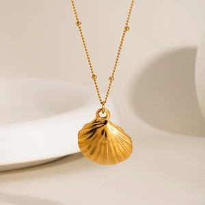 Golden titanium steel beaded necklace with a detailed scallop shell pendant in a minimal setting