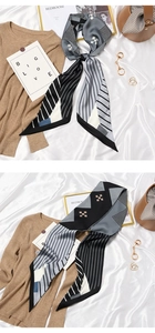 Macro detail of French retro silk scarf featuring black and white geometric patterns