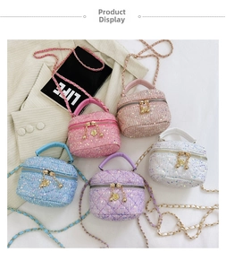 Detailed shot of quilted sequin crossbody bags with gold zippers and flower pendants