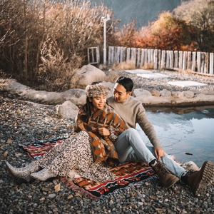Bohemian outdoor camping blanket with vintage geometric patterns used as a cozy picnic rug