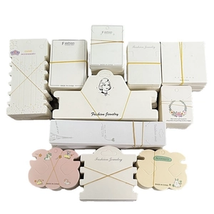 Assorted paper jewelry display cards in various shapes and colors for necklaces