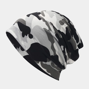Detailed view of camo beanie hat showing multi-layer knit texture and elastic fabric