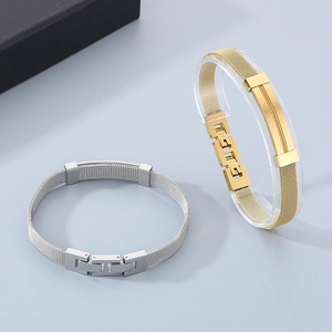 Close-up of gold and silver stainless steel mesh bracelet with adjustable buckle design