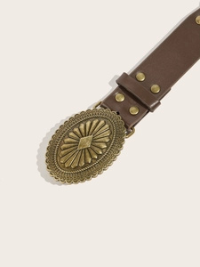 Detail of vintage brown faux leather belt with ornate bronze buckle and metallic studs