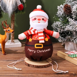 Detail of Christmas Santa drawstring gift bag on wood base with festive holiday decor