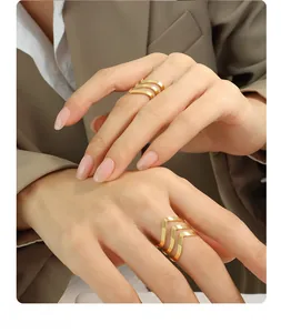 Close-up of triple-layered wave golden rings worn on hand for a modern minimalist style