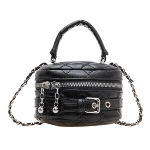 Black quilted leather cylinder mini handbag with silver chain strap and metal buckle