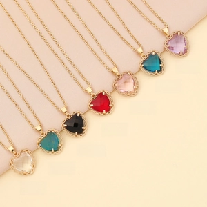 Detail view of heart shaped zircon pendant necklaces in seven various vibrant colors