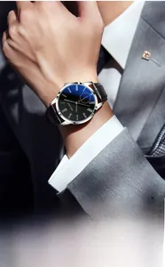 Business men's watch with blue dial and black leather strap worn with a gray suit