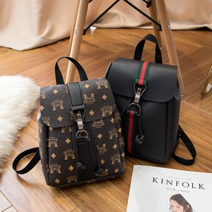 Mini floral and black PU leather knapsack for women shown in a cozy indoor lifestyle setting