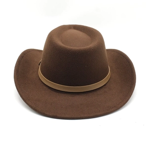 Detail of dark brown wool felt cowboy hat featuring a light khaki leather band and buckle