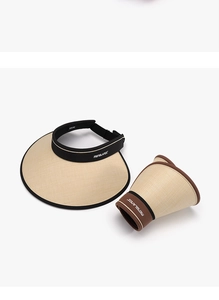 Detail showing the roll-up foldable design of the beige straw sun visor hat for travel
