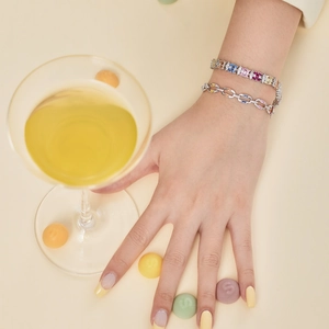 Close-up of S925 silver bracelet featuring colorful zircon stones worn by a model