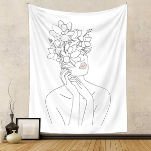 Detail of artistic floral female portrait line art tapestry on textured wall