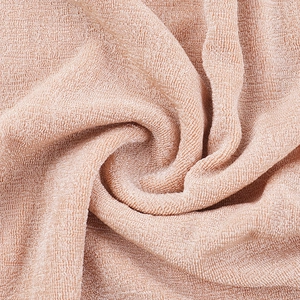 Macro shot of champagne gold ribbed fabric showing soft texture and high elasticity