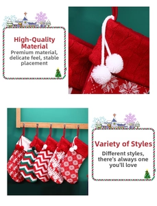 Detail of Nordic knit Christmas stockings with reindeer patterns and plush pompoms