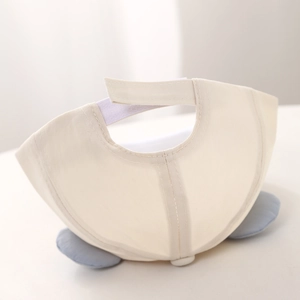 Detail of baby beige cap showing back velcro strap and blue soft ear decorative trim